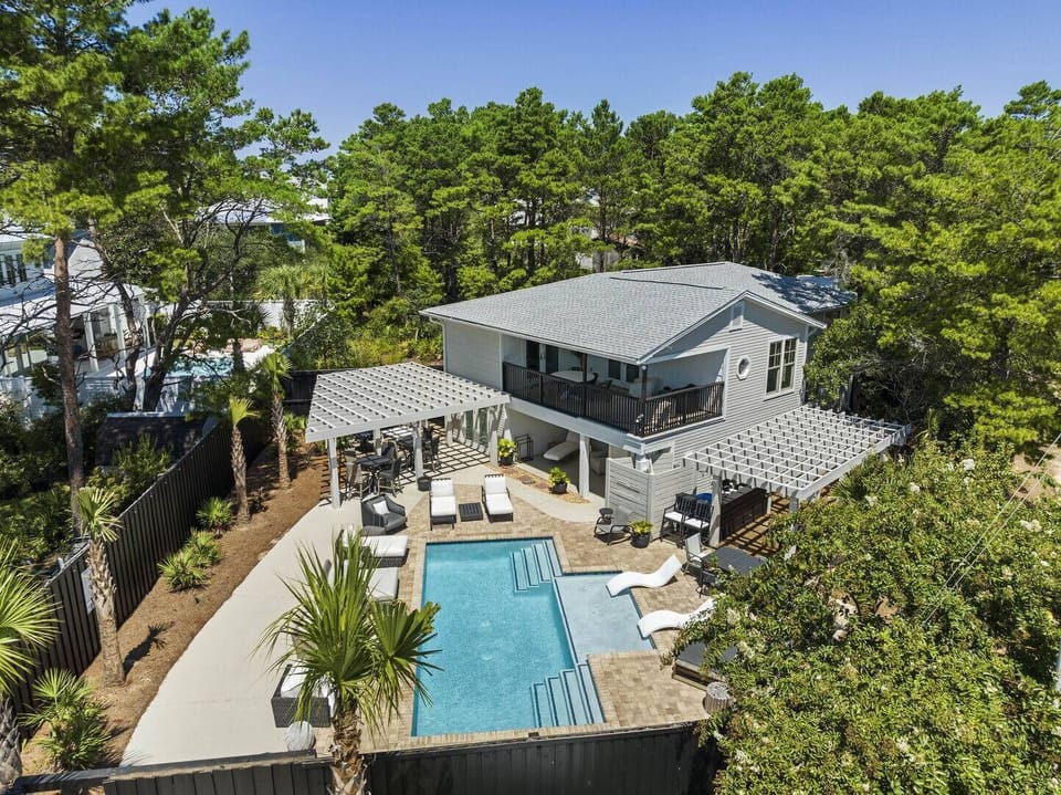 Aerial view showcasing the private pool nestled among lush greenery.