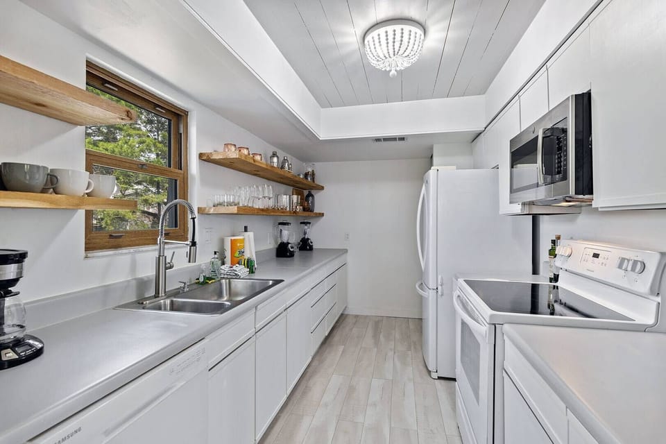 Bright galley kitchen w/ clean lines & plenty of prep space for easy home cooking.