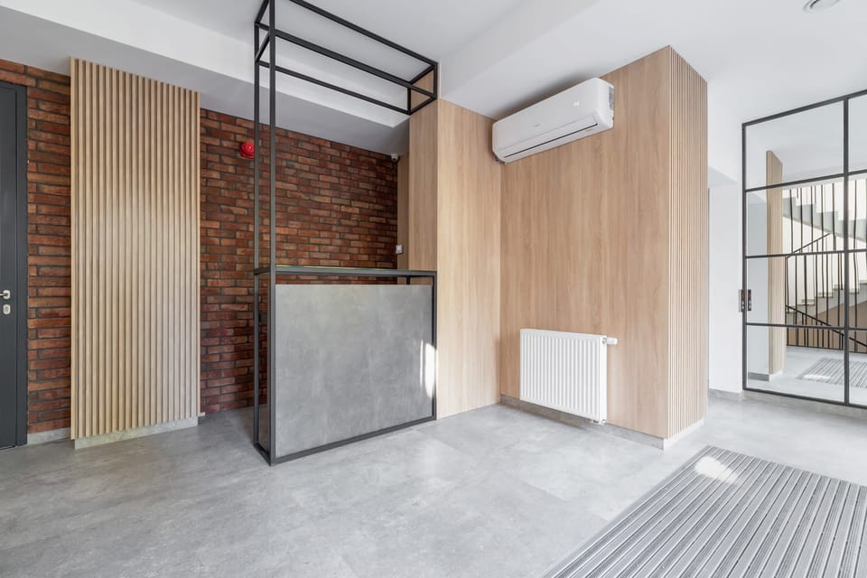 A modern shared area with exposed brick, wooden accents, and ample natural light.