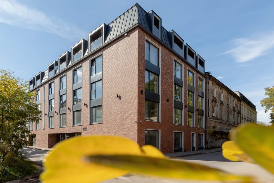 A view of the building’s exterior, showcasing its contemporary architecture and well-maintained surroundings.