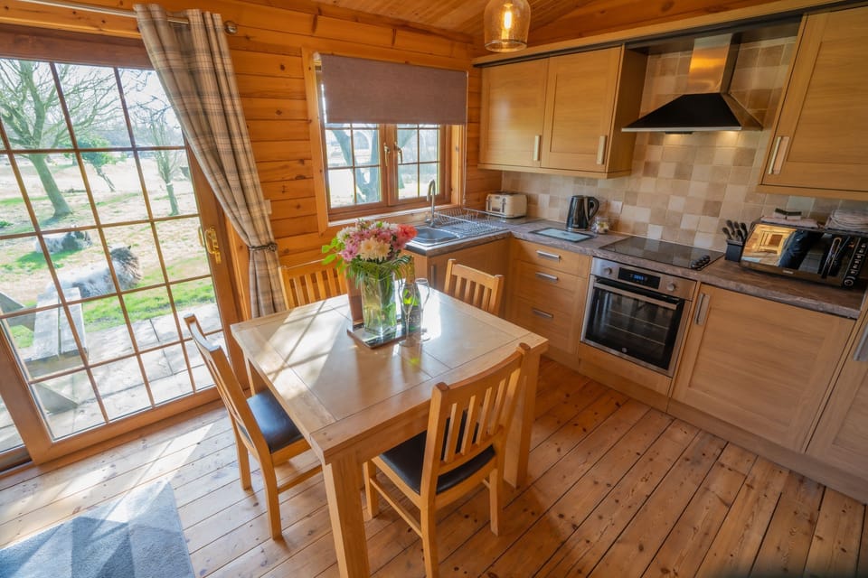 Kitchen area with oven, hob, kettle, toaster and microwave