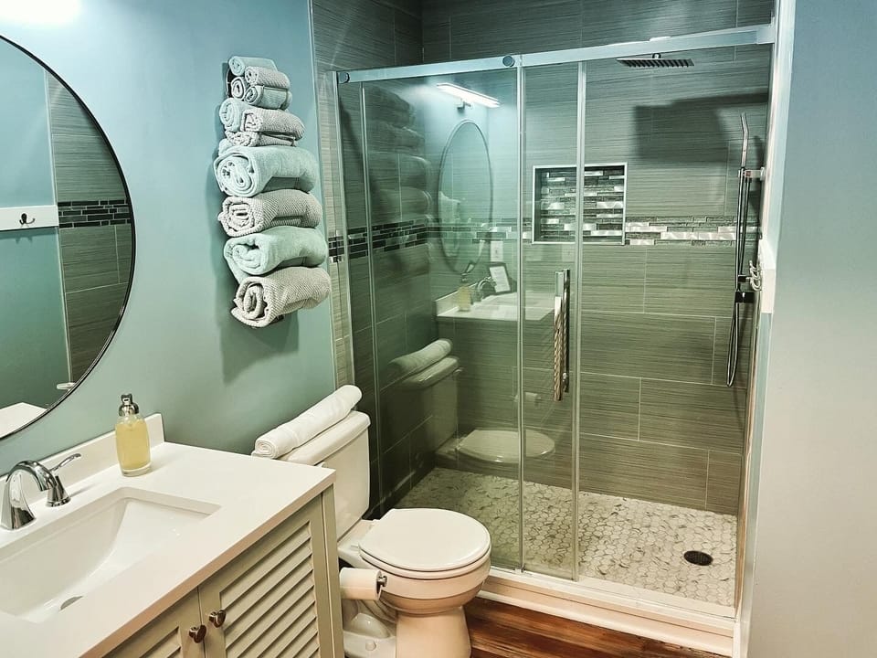 Luxious floor to ceiling shower with rainfall shower head and dual hand held.