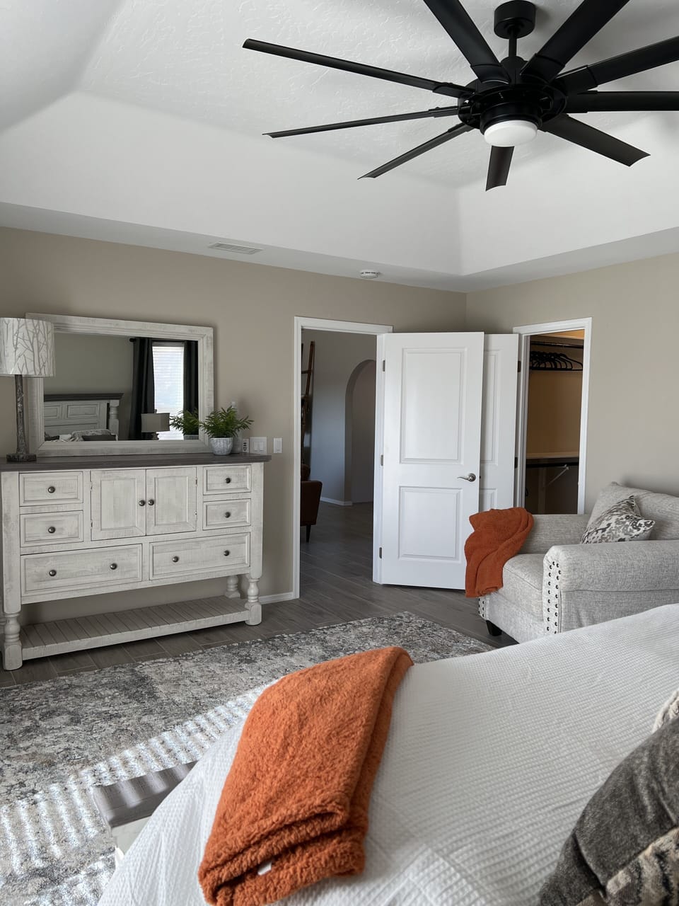 Master with large dresser and ceiling fan