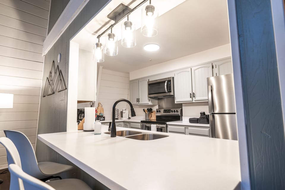 Newly renovated kitchen with bar seating for 3 and new stainless appliances