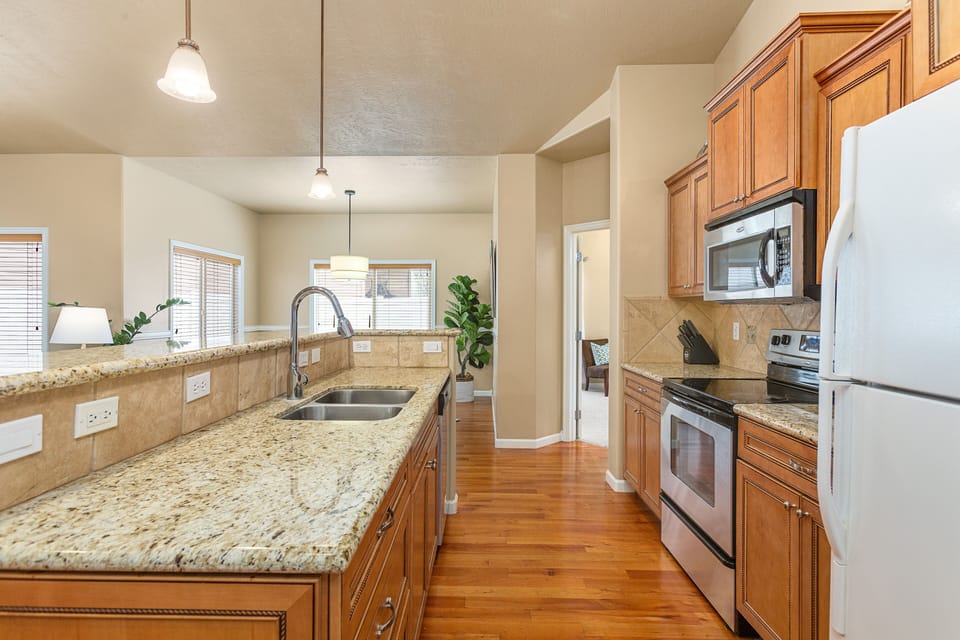 Galley Kitchen with Granite counters and Raised Bar for additional Seating.