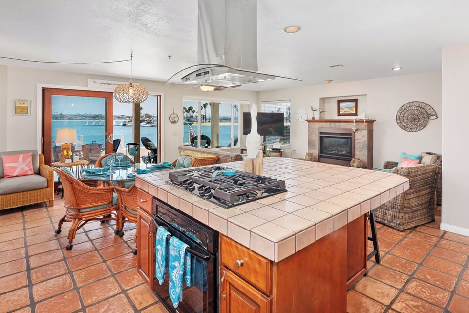 Open room concept with gas cooktop and large bar area, perfect for entertaining!