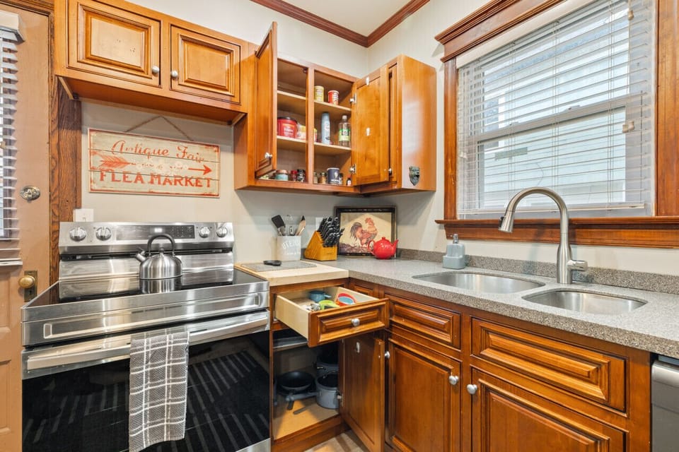 Kitchen stocked with knives, utensils, towels, spices, etc..