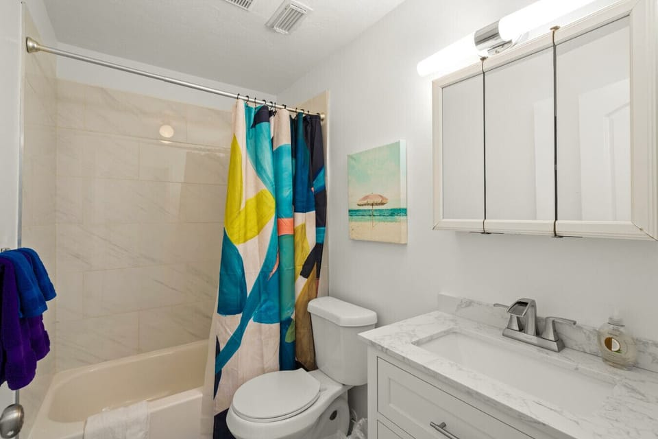 Siesta Key Beach Bathroom | Bold Abstract Shower Curtain, Coastal Artwork & Sleek Marble Vanity for a Bright, Beachy Feel