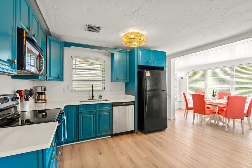 Siesta Key Beach Kitchen & Dining | Turquoise Cabinets, Red Chairs & Bold Coastal Contrast