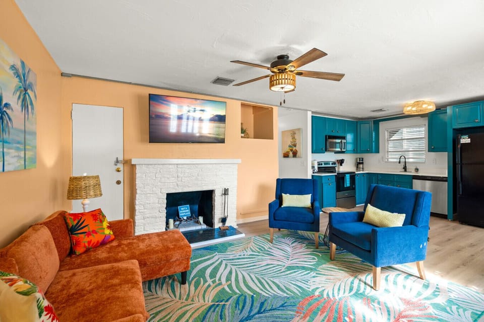 Siesta Key Beach Living Room| Leaf Rug, Sunset TV & Peach Walls in a Warm, Relaxed Setting