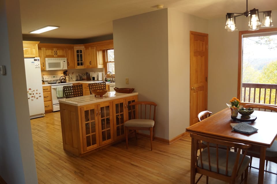 Peninsula adds addit. seating and space for conversation while preparing meals.