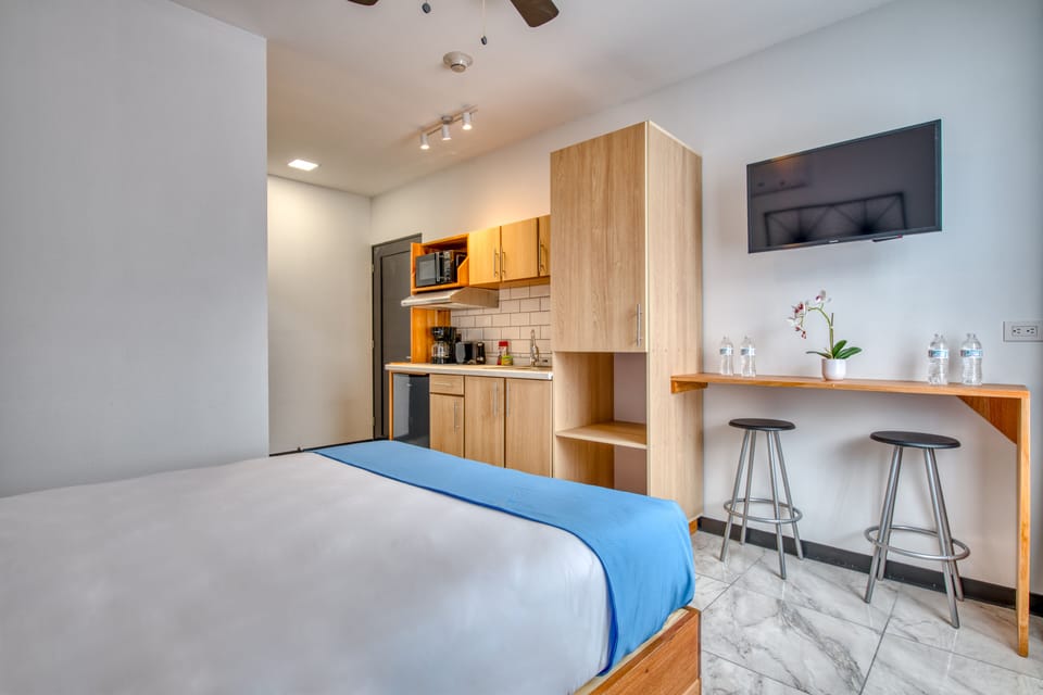 View from your Queen Bed to the TV, Seating Area, Private Kitchen