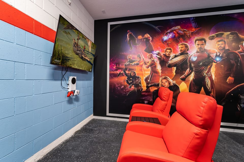 Games room with theater seating showing tv and xbox