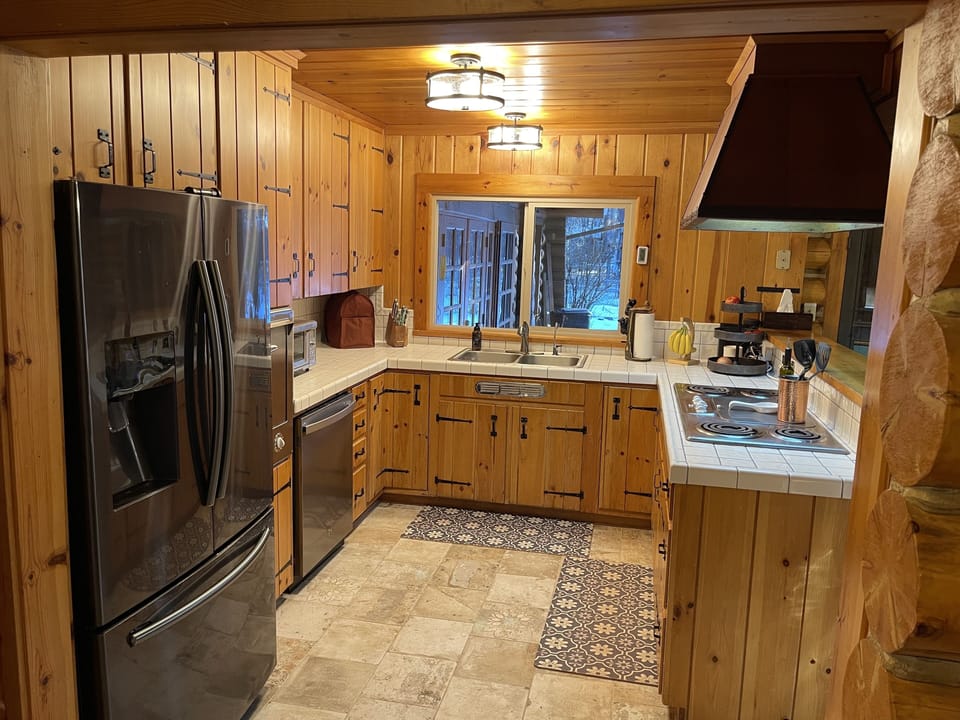 Kitchen is well stocked with amenities and open to great room and kitchen dining