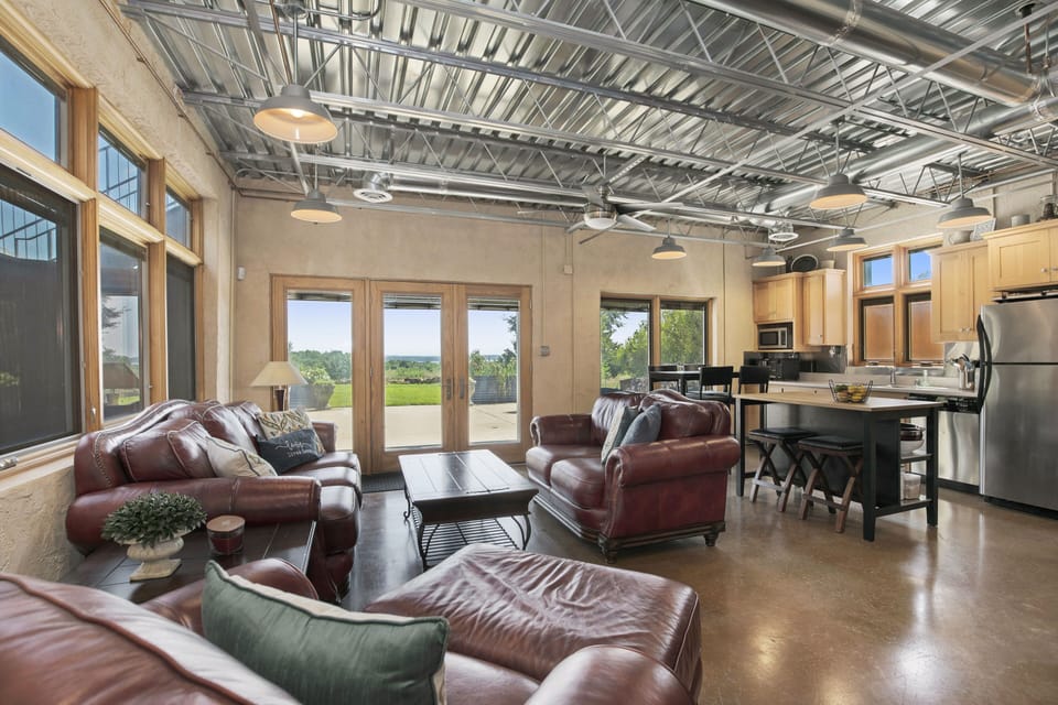 Lower level living room opens onto expansive patio with farmland and lake views