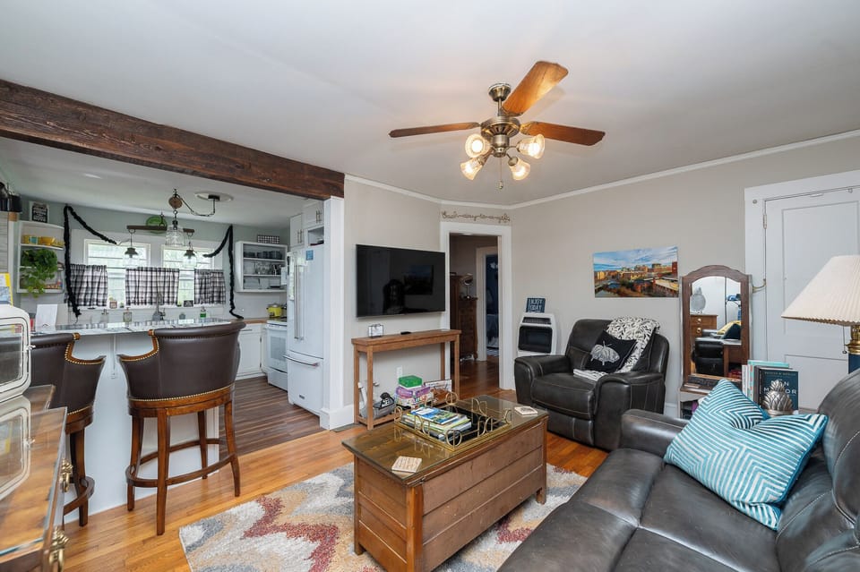 Open floor plan: Fully Equipped Kitchen to Living room with motorized forward reclining seats (3), Smart TV,   TV Console with hidden chamber for storing valuables. Games on shelves in full view and also in two drawers of the Coffee Table.