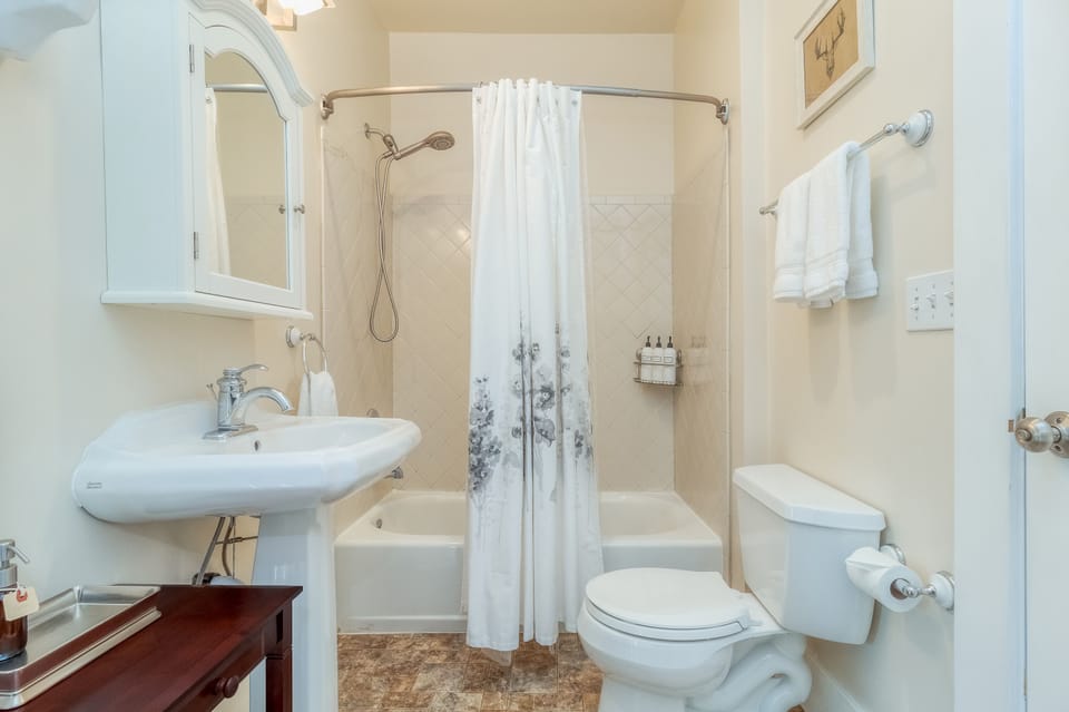 Main floor bathroom off the kitchen and entrance from the bedroom