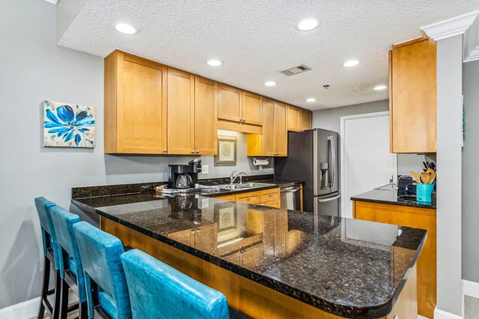 Breakfast bar with granite counters and 4 barstools