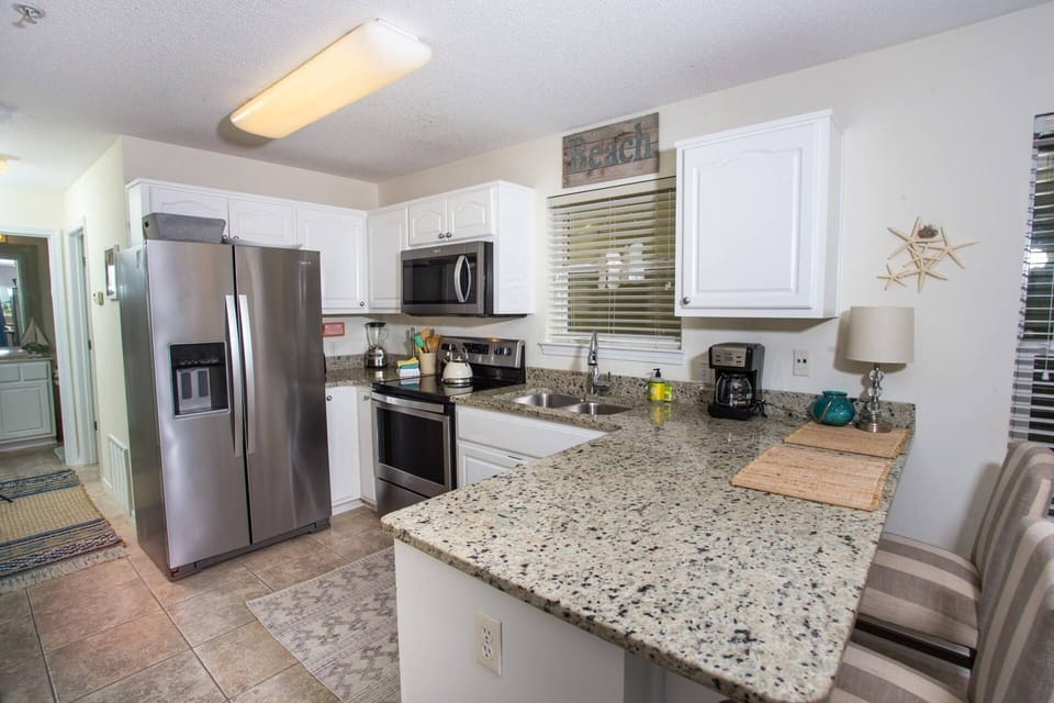 Open concept modern kitchen with stainless steel appliances