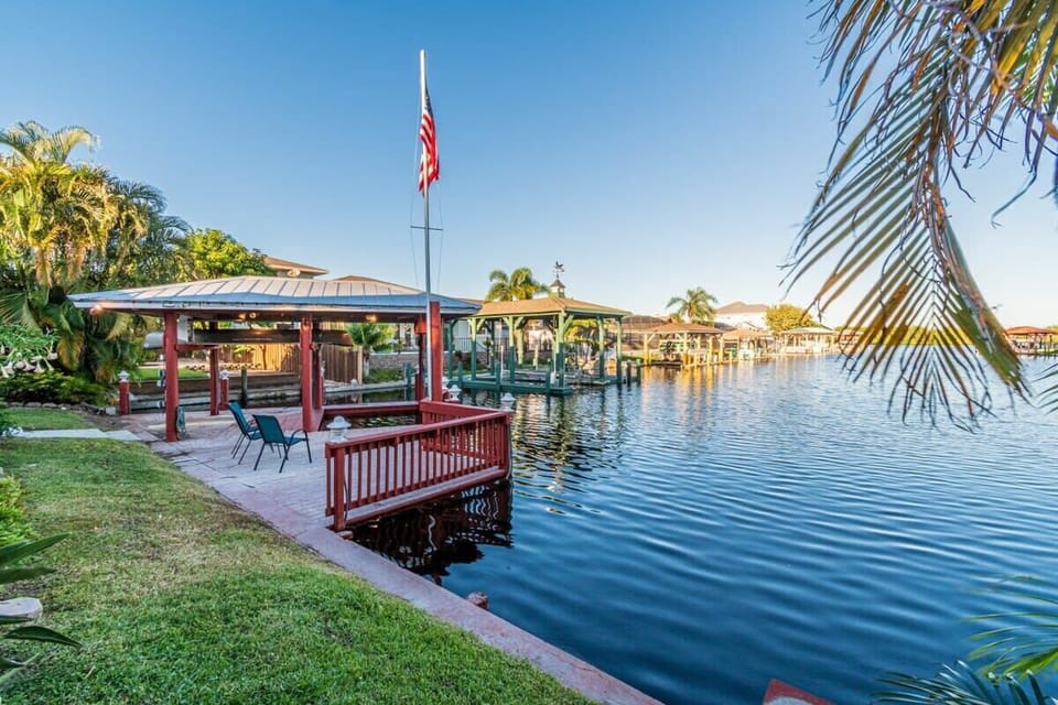 Relax by the waterfront gazebo with seating and scenic canal views.