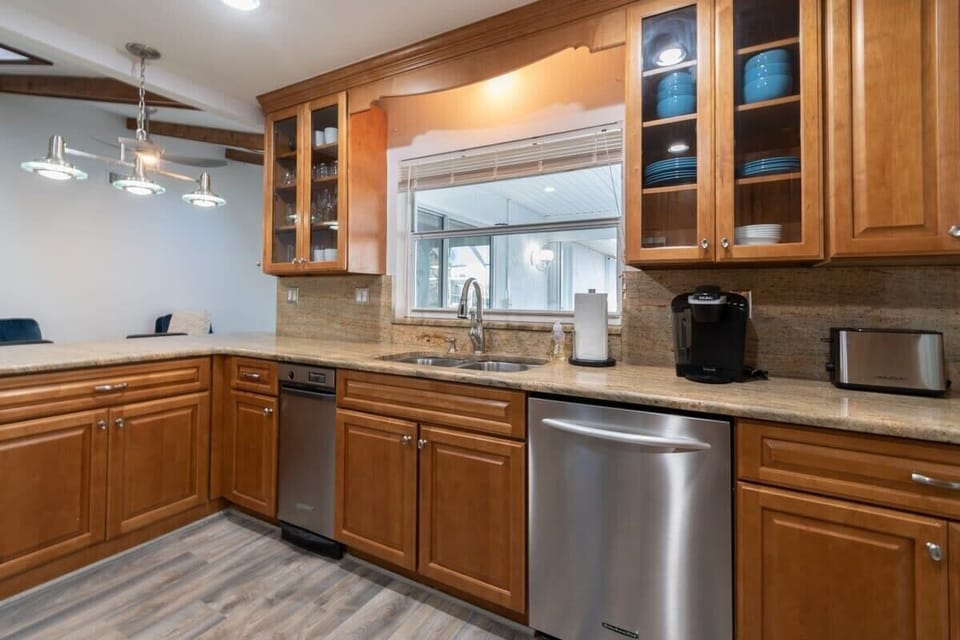 Modern kitchen with stainless steel appliances and wooden cabinetry.