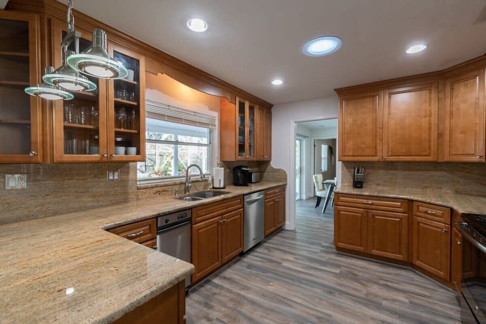 Spacious kitchen with granite countertops and warm wood cabinetry.