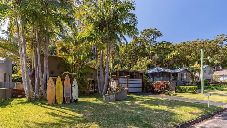 Exterior Front View with Garage and Palm Trees