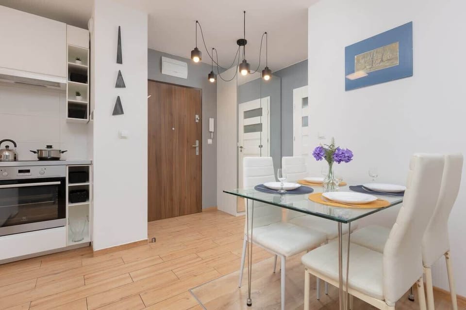 A modern, white kitchen with clean lines and integrated appliances, offering functionality and style.