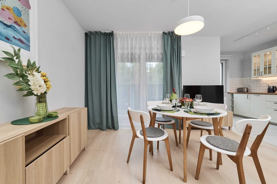 Functional yet stylish dining corner with ample storage and wooden touches creating a warm home atmosphere.


