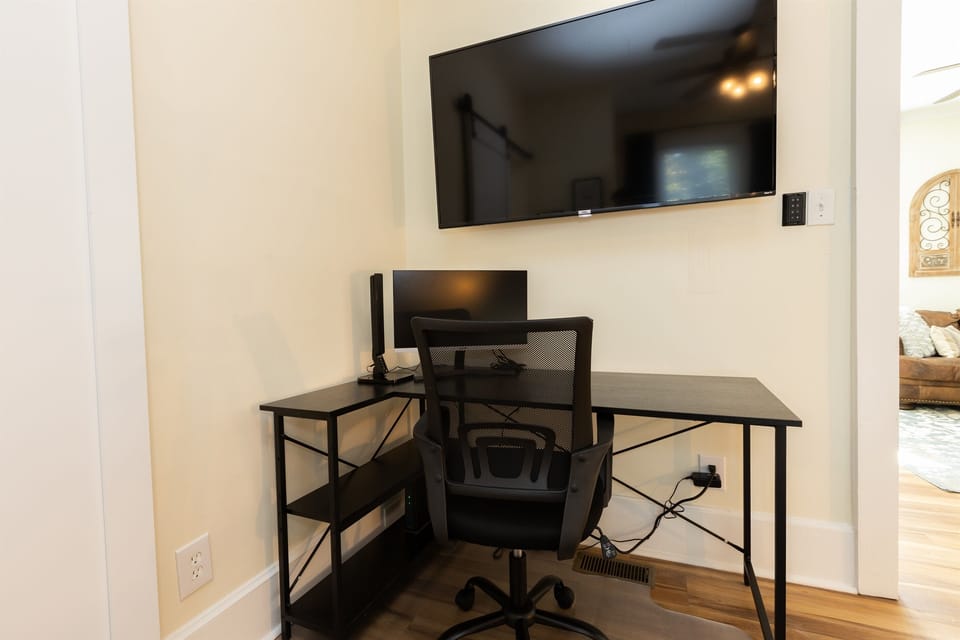 Bedroom #1 with King Bed, En-Suite Bathroom, Adjustable 55 inch ROKU TV, Work Station with desk, lamp and monitor, Sound Machine & Blackout Curtains
