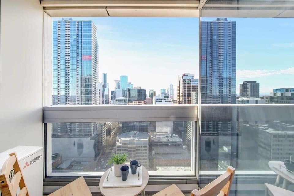 A balcony with city views. (chairs on balcony are from the dining area)