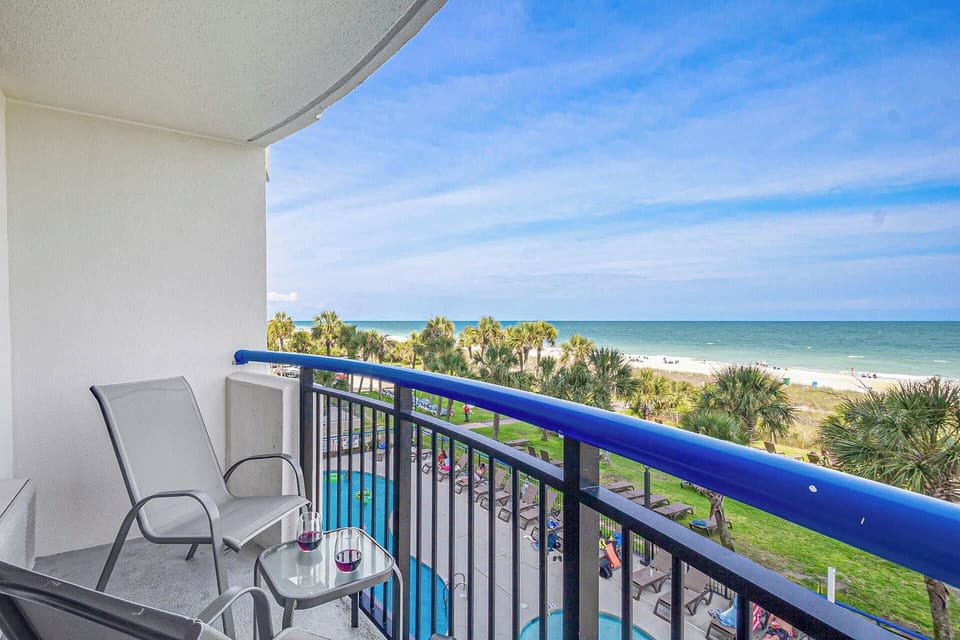 Step out onto your private balcony and soak in panoramic ocean views. With comfortable seating and a side table perfect for snacks or drinks, this serene spot invites you to unwind and enjoy the gentle sea breeze and the calming sound of the waves.