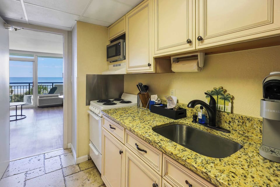 Bright, fully equipped kitchen with essential appliances and plenty of cabinet space for preparing meals during your stay.