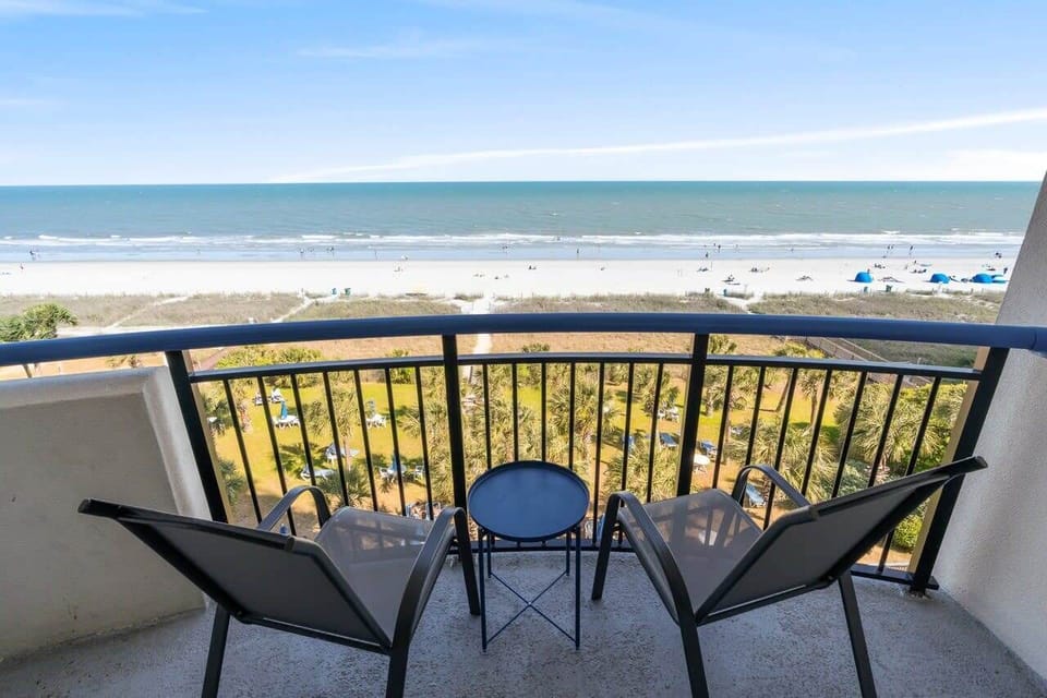 Sip your morning coffee or toast to sunset magic—this private balcony delivers front-row seats to the Atlantic with swaying palms below and salty breezes all around.