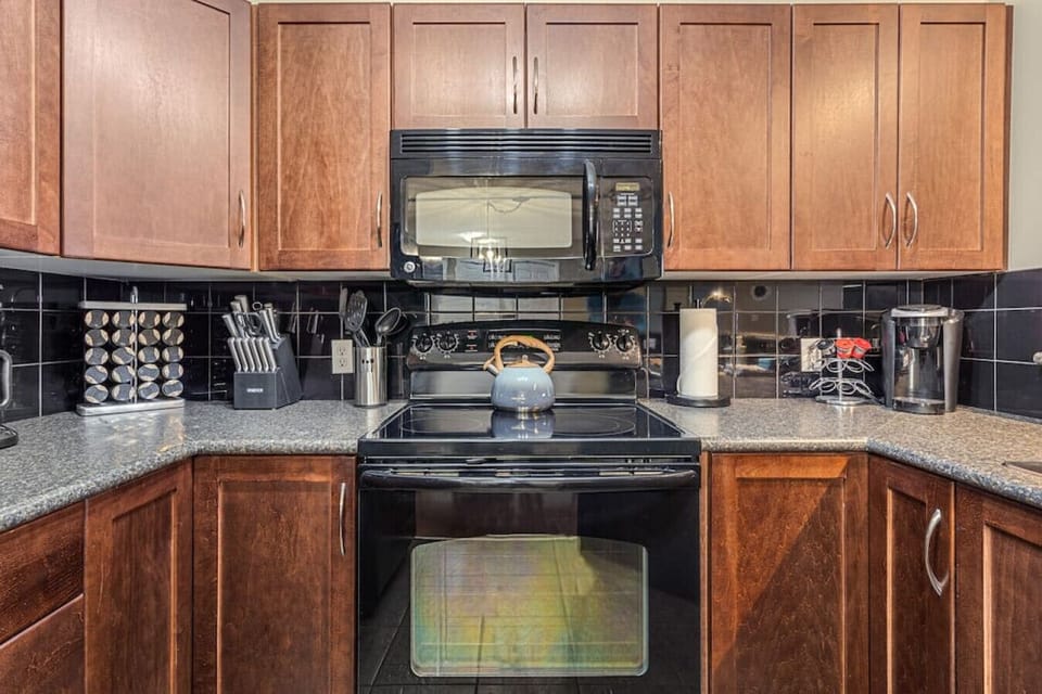 Full kitchen with a drip coffee machine, ground coffee, tea, sugar, and basic condiments (ketchup, mustard, relish.)