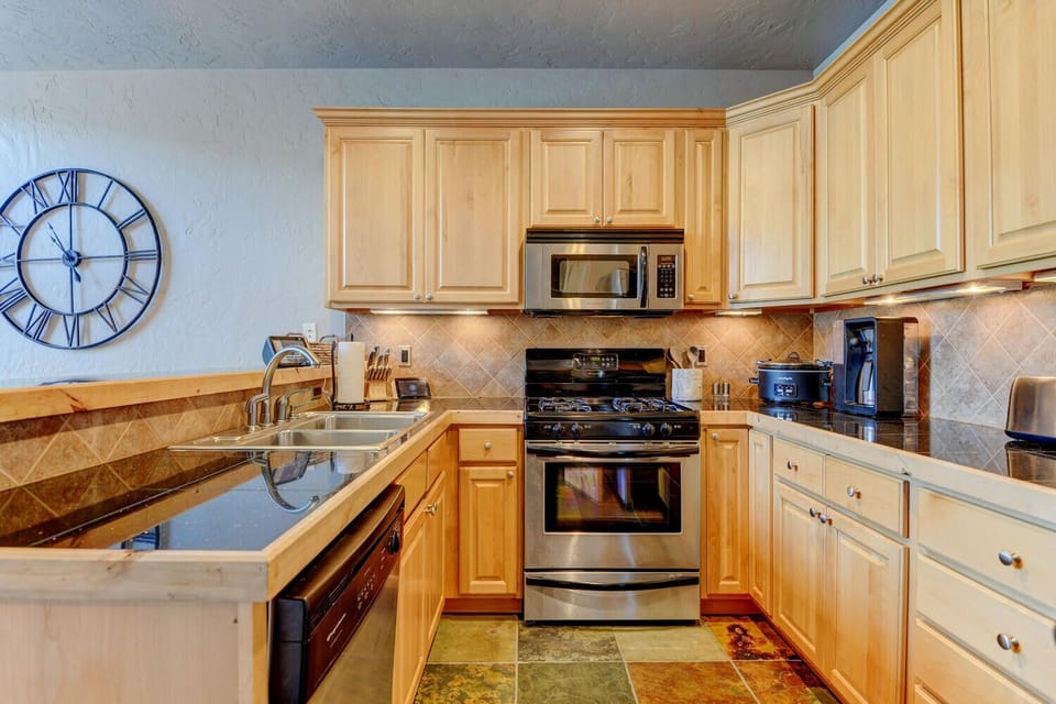 Dark Marbled Granite Shines Against The Beautiful Wood Cabinetry