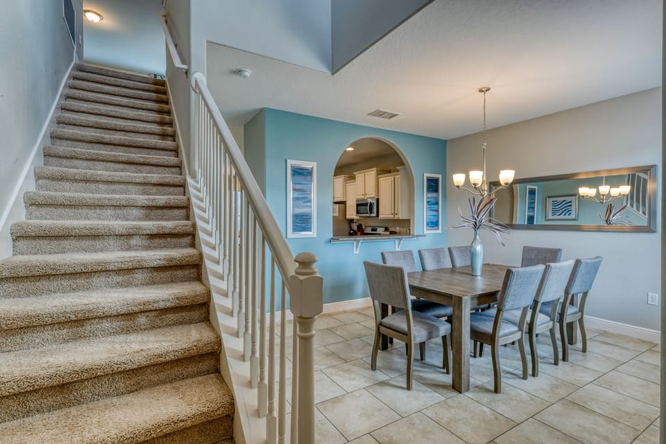 Entry showing stairs and formal dining room