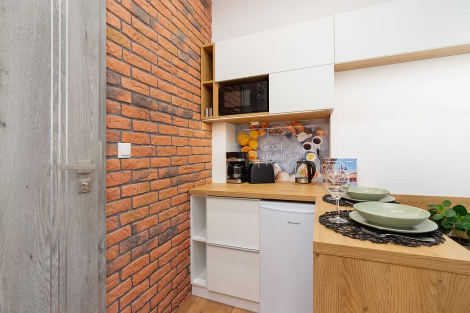 Another view of the kitchen with brick wall accents, adding a touch of industrial style to the decor.

