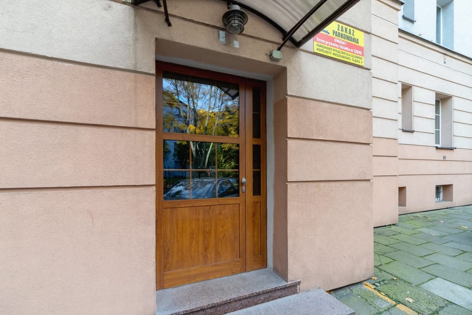 The exterior of the building, featuring a classic wooden door and well-maintained surroundings.
