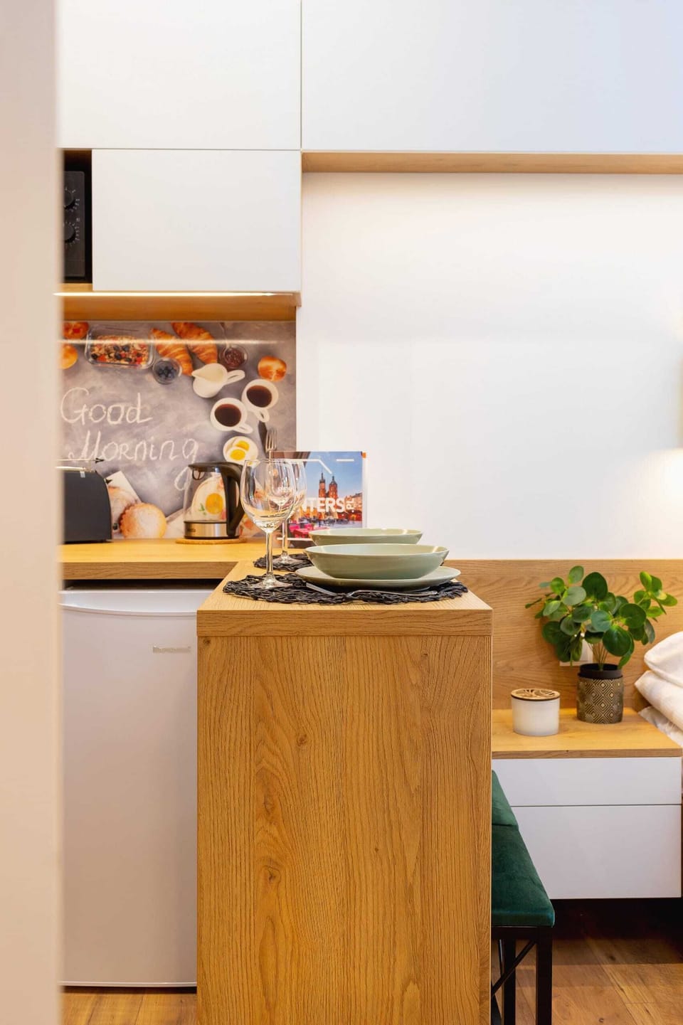 A close-up of the kitchen workspace, highlighting its clean layout and convenient storage options.
