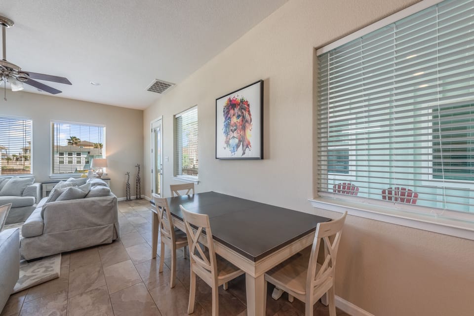 Gather around your bright dining table for meals and games, with comfortable seating and natural light streaming through large windows.