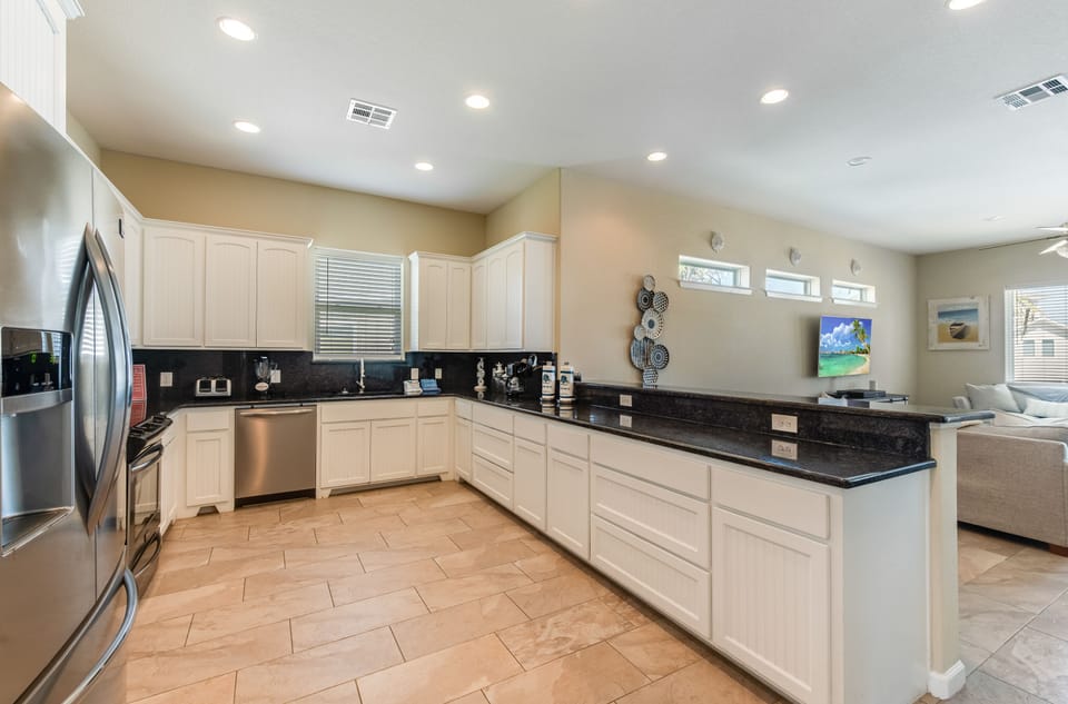 Your spacious gourmet kitchen features granite counters, stainless appliances, and bright open design connecting to your relaxing living area.