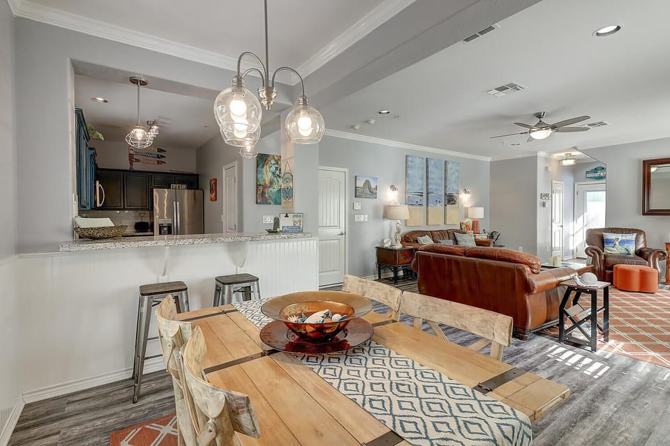 Relax in your open-concept space where rustic dining meets coastal elegance, complete with leather seating and modern kitchen.