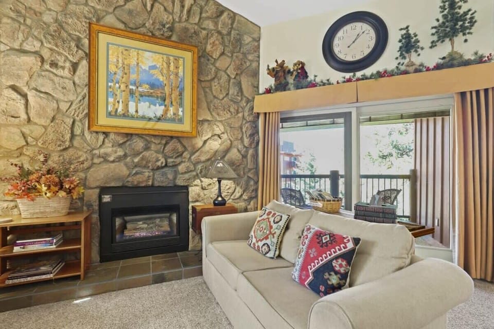 Stay connected to the group in the open-space living area as you relax in one of the three cozy sofas while taking in the high ceilings, impressive stone-finished fireplace, and views from the large windows.