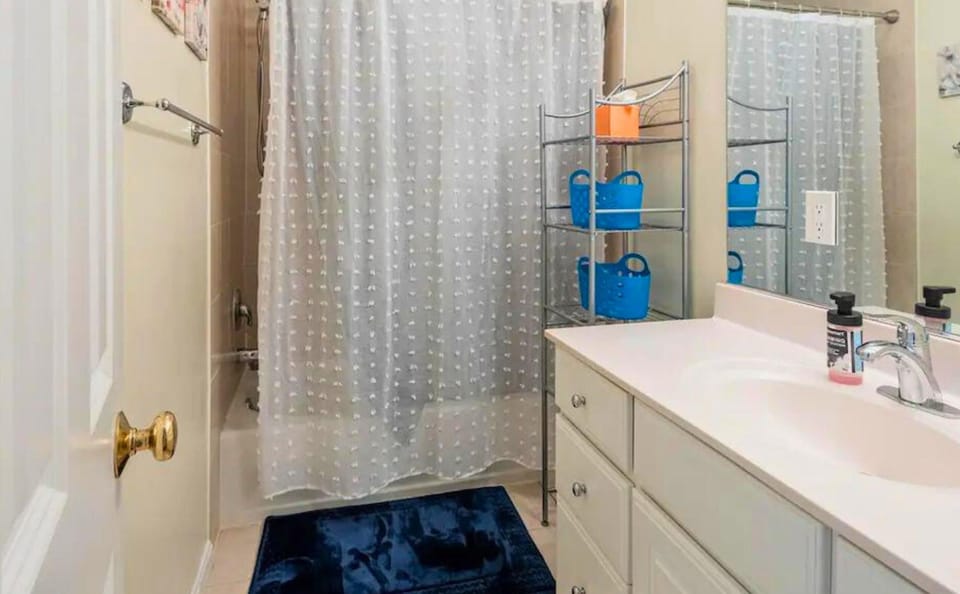 Freshen up in this modern bathroom featuring a sleek sink, geometric tiles, and contemporary fixtures for a luxurious experience.