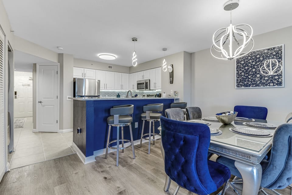 Gather around your stylish blue island kitchen where conversations flow as easily as the coffee from your modern appliances.