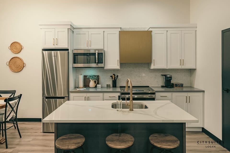  Oven, microwave, refrigerator, freezer, coffee maker, dishes, and a dishwasher.
