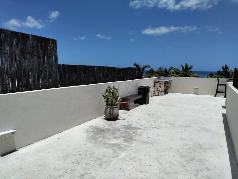 Shared rooftop with ocean view, exterior furniture and BBQ area