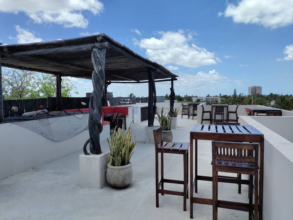 Shared rooftop with ocean view, exterior furniture and BBQ area