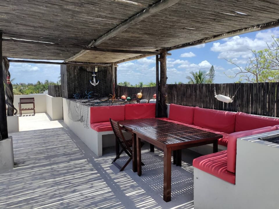Shared rooftop with ocean view, exterior furniture and BBQ area